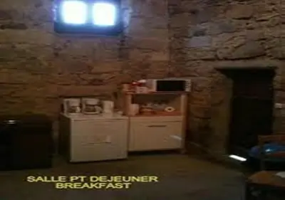 a kitchen with a small refrigerator and a window at Auberge de Jeunesse Chez Mc Donald in Zevaco