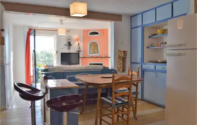 a kitchen and living room with a table and chairs at Lovely Apartment In Serra Di Ferro in Serra-di-Ferro