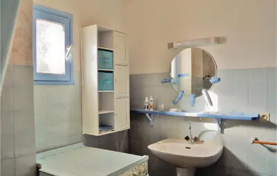 a bathroom with a sink and a mirror at Lovely Apartment In Serra Di Ferro in Serra-di-Ferro
