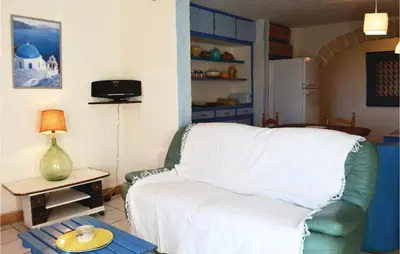 a living room with a white couch and a table at Lovely Apartment In Serra Di Ferro in Serra-di-Ferro