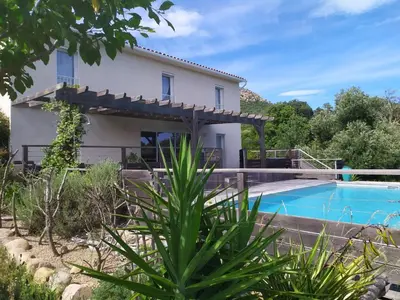 a villa with a swimming pool and a house at Maison d' Hôtes L'Aria Mezzana in Sainte-Lucie de Porto-Vecchio