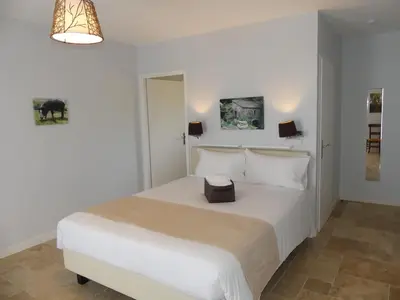 a white bedroom with a white bed with a box on it at Maison d' Hôtes L'Aria Mezzana in Sainte-Lucie de Porto-Vecchio