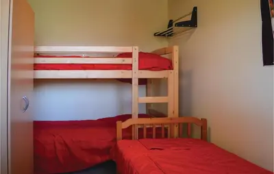 a bedroom with two bunk beds and a bed at Two-Bedroom Holiday Home In Calcatoggio in Calcatoggio