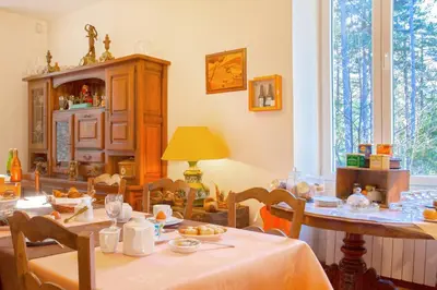 a dining room with a table and chairs at Casa Alta in Vizzavona