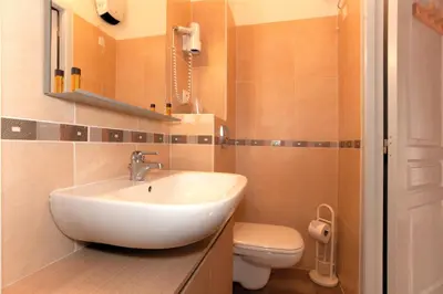 a bathroom with a sink and a toilet at Casa Alta in Vizzavona