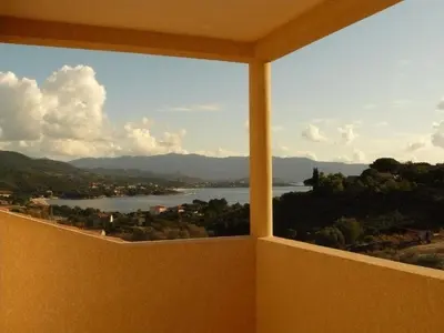 a room with a view of a river and mountains at Sci Albellu in Sagone