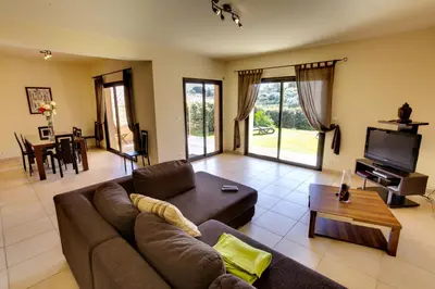 a living room with a couch and a tv at Sci Albellu in Sagone
