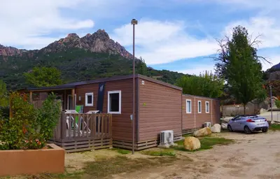 a tiny house with a mountain in the background at Funtana a l'Ora in Porto Ota