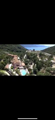 an aerial view of a resort with a swimming pool at Hotel Stella Marina in Serriera