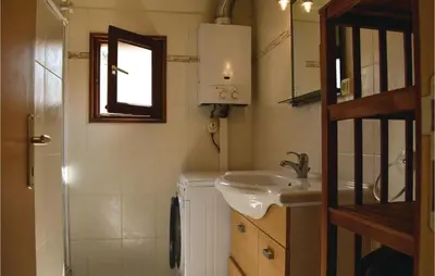 a small bathroom with a sink and a mirror at Three-Bedroom Holiday Home In Calcatoggio in Calcatoggio