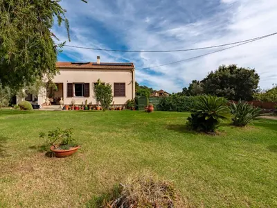 a house in a yard with a yard sidx sidx sidx at Apartment Villa Volpajola by Interhome in Cervione