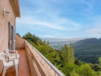 a couple of white benches sitting outside of a building at Holiday Home Filippi by Interhome in San-Giovanni-di-Moriani