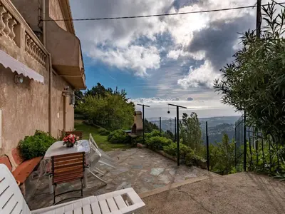 a balcony with two chairs and a view of the mountains at Holiday Home Filippi by Interhome in San-Giovanni-di-Moriani