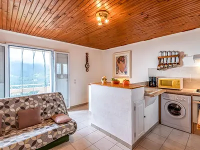 a kitchen with a white refrigerator and a table at Holiday Home Filippi by Interhome in San-Giovanni-di-Moriani