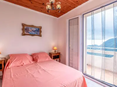 a bedroom with a bed and a large window at Holiday Home Filippi by Interhome in San-Giovanni-di-Moriani