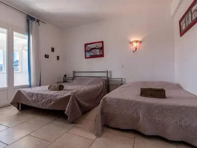 a bedroom with two beds and a window at Holiday Home La Cerisaie by Interhome in Santa-Lucia-di-Moriani