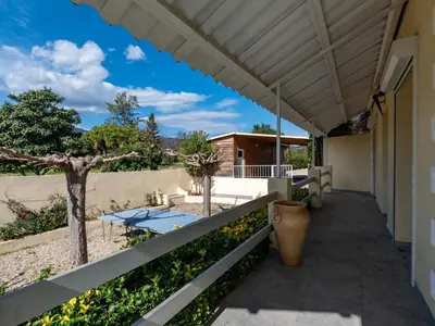 a patio with a table and a fence at Holiday Home La Cerisaie by Interhome in Santa-Lucia-di-Moriani
