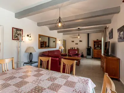 a living room with a table and a couch at Holiday Home La Cerisaie by Interhome in Santa-Lucia-di-Moriani
