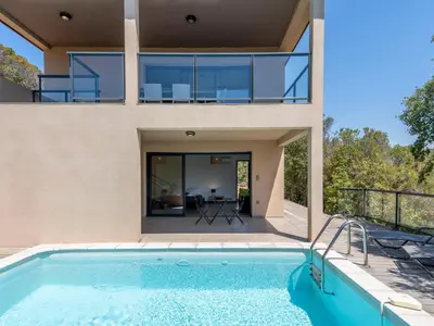 a villa with a swimming pool and a house at Holiday Home Bruyères 1 by Interhome in Porticcio