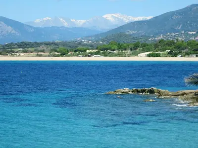 a large body of water with a beach and mountains at Holiday Home Bruyères 1 by Interhome in Porticcio