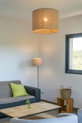 a living room with a couch and a table at Holiday Home Bruyères 1 by Interhome in Porticcio