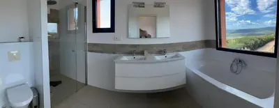 a white bathroom with a sink and a bath tub at Villa Santa Giulia, vue panoramique sur la mer, 900 m de la plage in Porto-Vecchio