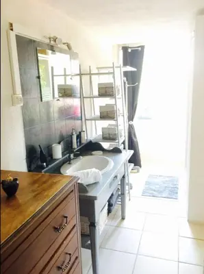 a bathroom with a sink and a mirror at Bas De Maison in Olivese