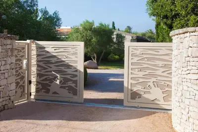 a pair of gates in a driveway at Studio Cartarana in Bonifacio