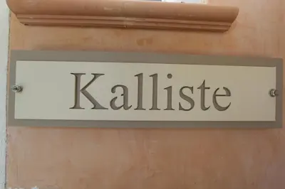a sign that reads kalleice hanging on a wall at Studio Cartarana in Bonifacio