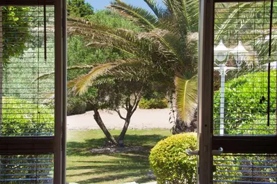 an open window with a view of the beach at Studio Cartarana in Bonifacio