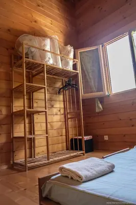 a bedroom with bunk beds in a wooden room at Les Terrasses de Scaglioli in Villanova