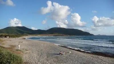 a group of people on a beach near the water at Les Terrasses de Scaglioli in Villanova
