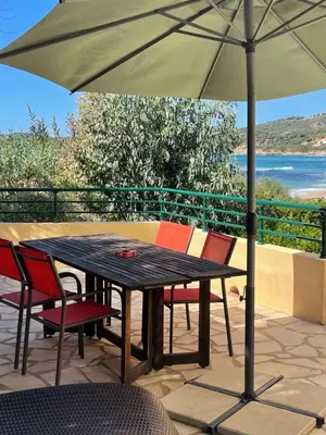 a bedroom with a bed and a ceiling fan at Hotel Thalassa in Cargèse