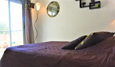 a bedroom with a purple bed and a mirror at COLOMBA in Conca