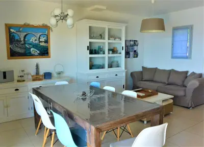 a kitchen and living room with a table and chairs at COLOMBA in Conca
