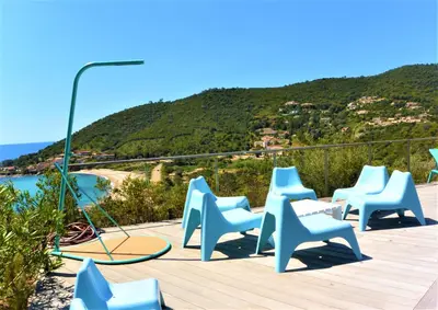 a group of blue chairs sitting on a wooden deck at COLOMBA in Conca