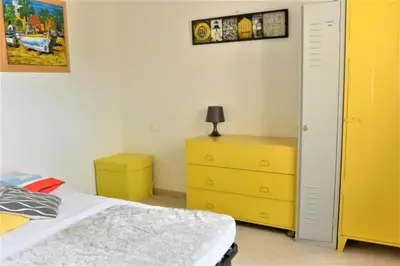 a bedroom with a bed and a yellow dresser at COLOMBA in Conca