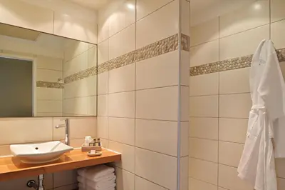 a bathroom with a sink and a mirror at Hôtel Abbartello in Olmeto