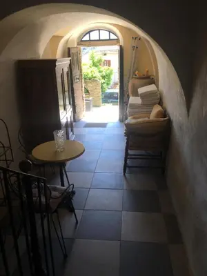 a hallway with a table and a table and chairs at Appartement 2 chambres A Casa De Giovanni à Pietra-di-Verde en Haute-Corse in Pietra-di-Verde