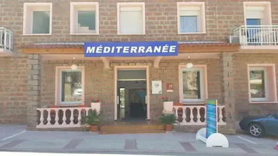 a building with a sign that reads medicine entrance at Le Méditerranée in Porto Ota