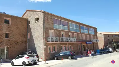 a brick building with cars parked in front of it at Le Méditerranée in Porto Ota