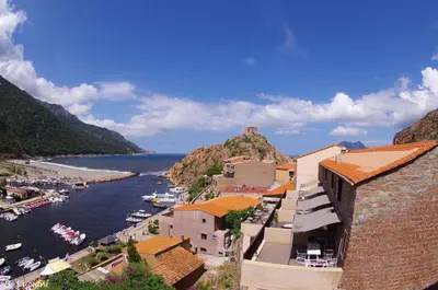 a view of a town on a hill next to the water at Le Méditerranée in Porto Ota