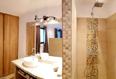 a bathroom with two sinks and a shower at Maredda 2 in Sartène
