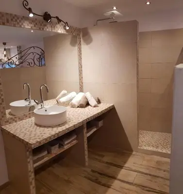 a bathroom with two sinks and a shower at Maredda 2 in Sartène