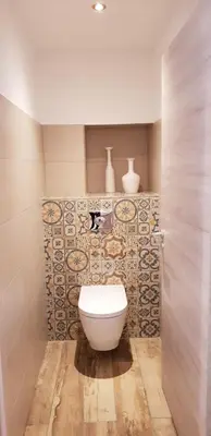a bathroom with a toilet and vases on the wall at Maredda 2 in Sartène