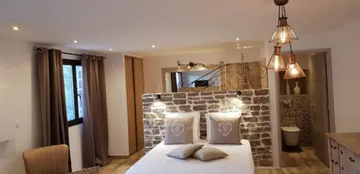 a bedroom with a brick wall and a bed with pillows at Maredda 2 in Sartène