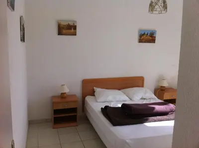 a bedroom with a bed with two night stands and two lamps at Villa Romarin in Partinello
