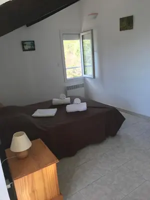 a bedroom with a large bed and a window at Villa Romarin in Partinello