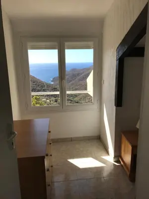 a kitchen with a large window with a view of the ocean at Villa Romarin in Partinello