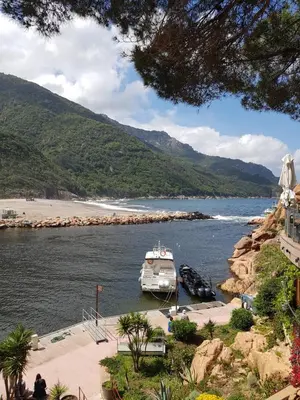 a boat in the water near a beach at Le monte rosso in Porto Ota